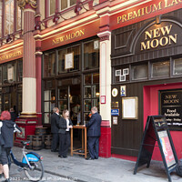 Buy canvas prints of People drinking outside the New Moon public house  by Kevin Hellon