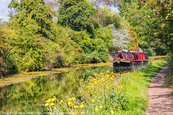 A narrowboat makes its way along the Grand Union canal  Picture Board by Kevin Hellon