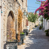 Buy canvas prints of Narrow street with stone houses by Kevin Hellon