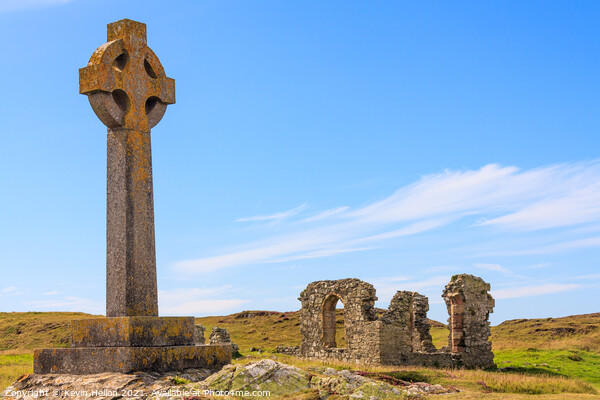 Celtic cross and the remains of St. Dwynwen church Picture Board by Kevin Hellon