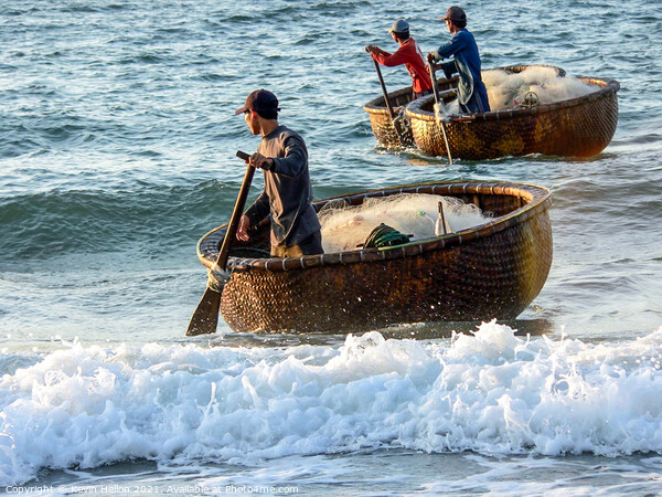 Fishermen returning in their coracles Picture Board by Kevin Hellon