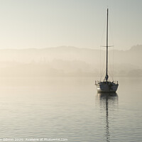 Buy canvas prints of Stunning unplugged fine art landscape image of sailing yacht sitting still in calm lake water in Lake District during peaceful misty Autumn Fall sunrise by Matthew Gibson