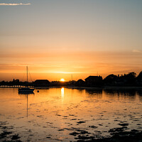 Buy canvas prints of Beautiful Summer sunset landscape over low tide harbor with moored boats by Matthew Gibson