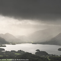 Buy canvas prints of Stunning epic landscape image across Derwentwater valley with falling rain drifting across the mountains causing pokcets of light and dark across the countryside by Matthew Gibson