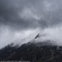 Buy canvas prints of Stunning detail landscape images of snowcapped Pen Yr Ole Wen mountain in Snowdonia during dramatic moody Winter storm by Matthew Gibson