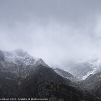 Buy canvas prints of Stunning moody dramatic Winter landscape image of snowcapped Y Garn mountain in Snowdonia by Matthew Gibson