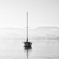 Buy canvas prints of Stunning unplugged fine art landscape image of sailing yacht sitting still in calm lake water in Lake District during peaceful misty Autumn Fall sunrise by Matthew Gibson