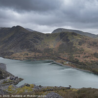 Buy canvas prints of Beautiful landscape image of Dinorwig Slate Mine and snowcapped Snowdon mountain in background during Winter in Snowdonia with Llyn Peris in foreground by Matthew Gibson