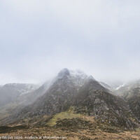 Buy canvas prints of Stunning moody dramatic Winter landscape image of snowcapped Y Garn mountain in Snowdonia by Matthew Gibson