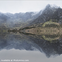 Buy canvas prints of Beautiful moody Winter landscape image of Llyn Idwal and snowcapped Glyders Mountain Range in Snowdonia by Matthew Gibson
