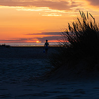 Buy canvas prints of Lone Boy at sunset by Simon Wilkinson