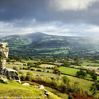 Buy canvas prints of Sugar Loaf and Skirrid under a Stormy Sky. by Philip Veale