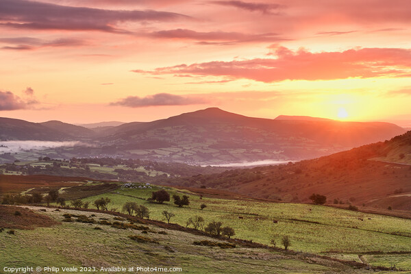 Sugar Loaf and Skirrid Golden Sunrise. Picture Board by Philip Veale