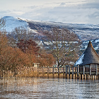 Buy canvas prints of Llangorse Lake Crannog and Mynydd Troed in Winter. by Philip Veale