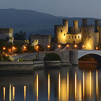 Buy canvas prints of Conwy Castle's Dusk Illumination by Philip Veale