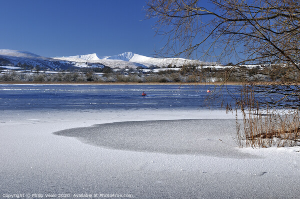 Llangorse Lake and Brecon Beacons in Winter. Picture Board by Philip Veale