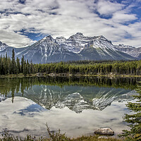 Buy canvas prints of Mountain reflections in lake by Chantal Cooper