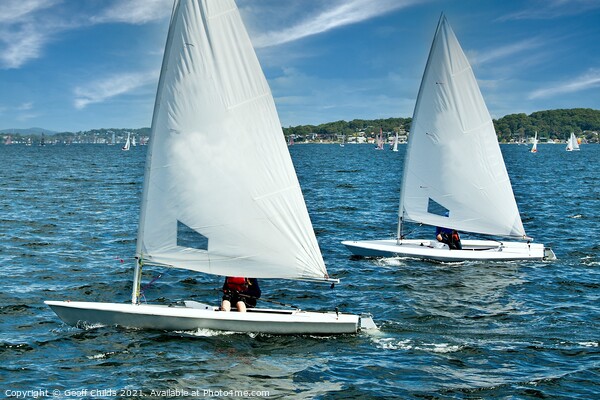Teens racing in small sailboat with white sails. Picture Board by Geoff Childs