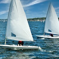 Buy canvas prints of Teens racing in small sailboat with white sails. by Geoff Childs