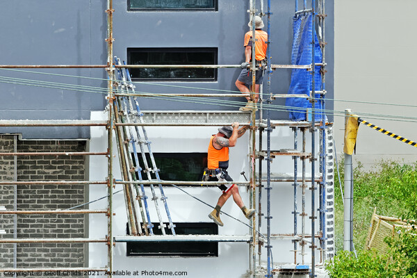 Construction workers dismantling scaffolding on new construction Picture Board by Geoff Childs