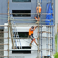 Buy canvas prints of Construction workers dismantling scaffolding on new construction by Geoff Childs