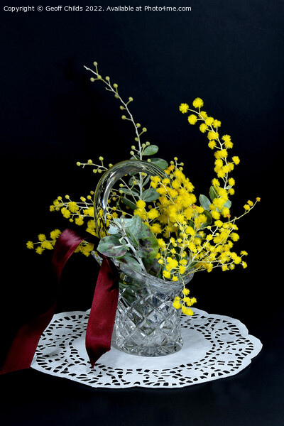 Wattle blossoms in a crystal glass vase vase on black. Wattle da Picture Board by Geoff Childs