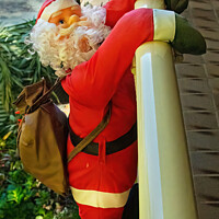 Buy canvas prints of  Christmas theme image with Santa climbing over a balcony. by Geoff Childs
