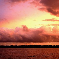 Buy canvas prints of Cloud bank highlighted sunset seascape.  by Geoff Childs
