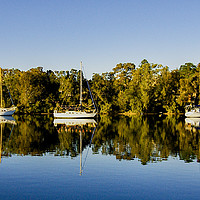 Buy canvas prints of Lake landscape waterscape with boat reflections. by Geoff Childs