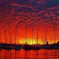 Buy canvas prints of Vibrant red colored cloudy sunset seascape.   by Geoff Childs