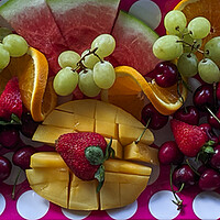 Buy canvas prints of A colourful Christmas breakfast fruit platter on a dining table closeup. by Geoff Childs