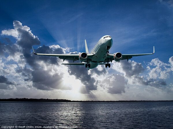 Jet Airliner Flying in subeams Picture Board by Geoff Childs