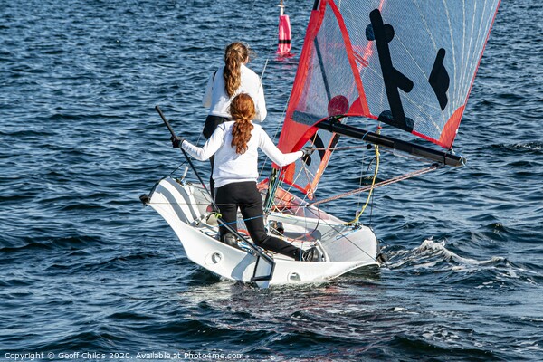 Two Girls Sailing small sailboat. Picture Board by Geoff Childs