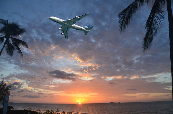 Aircraft flying in tropical dawn sky. Thailand. Picture Board by Geoff Childs