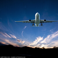 Buy canvas prints of Jet Airliner Flying in a sunset sky. by Geoff Childs