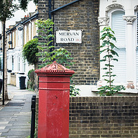 Buy canvas prints of Red post box in Mervan Road, London by Angela Bragato