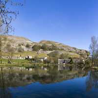 Buy canvas prints of Kilnsey Trout Farm Lake with Kilnsey Crag in the background. by Chris North