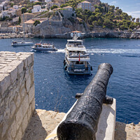 Buy canvas prints of Canon standing guard over Hydra harbour entrance. by Chris North