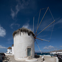Buy canvas prints of Windmills overlooking Mykonos town. by Chris North