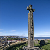Buy canvas prints of Celtic cross overlooking the seaside town of Whitby. by Chris North