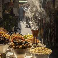 Buy canvas prints of Aromatic herbs smouldering at the spice souk in Dubai. by Chris North