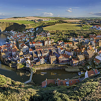 Buy canvas prints of Staithes harbour and village. by Chris North