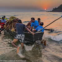 Buy canvas prints of Goa, fisherman launching boat at sunset. by Chris North