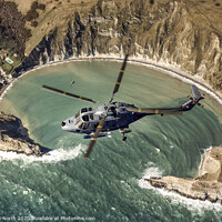 Buy canvas prints of Royal Navy Lynx over Lulworth Cove by Chris North