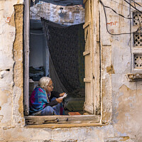 Buy canvas prints of Lady reading letter in doorway, Jaisalmer Fort. by Chris North