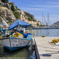 Buy canvas prints of Fisherman repairing nets at Symi harbour. by Chris North