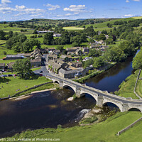 Buy canvas prints of Burnsall Village and the river Wharfe. by Chris North