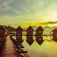 Buy canvas prints of Sunrise over lake huts by  