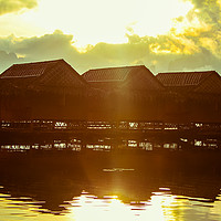 Buy canvas prints of Beautiful sunrise over wooden lake huts by  