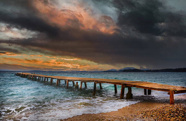 The Old wooden Jetty at Ipsos beach in Corfu at Sunrise Picture Board by Dave Williams